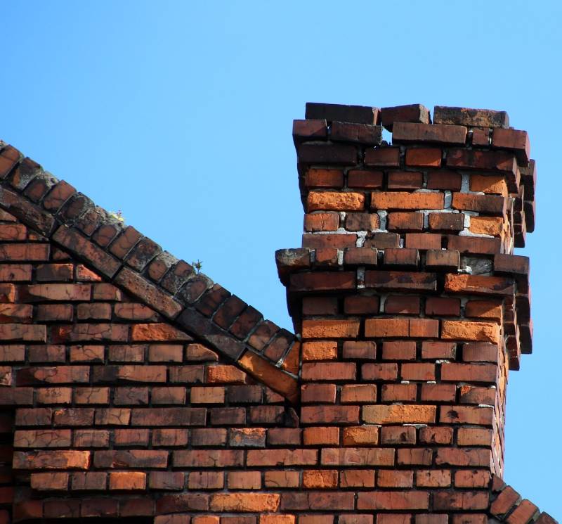 Damaged chimney on an Compton home showing cracks and missing mortar